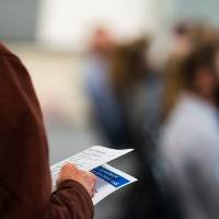 Close up on abstract book in guest's hand.